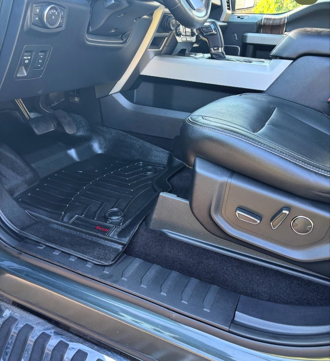 Interior detail close-up with pristine leather seats and WeatherTech mats